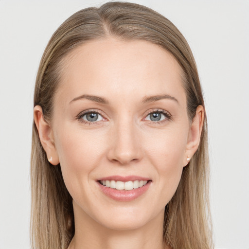 Joyful white young-adult female with long  brown hair and grey eyes