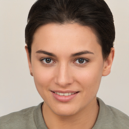 Joyful white young-adult female with short  brown hair and brown eyes