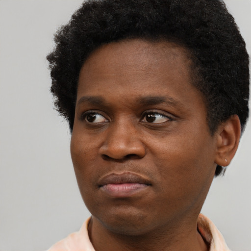 Joyful black young-adult male with short  brown hair and brown eyes