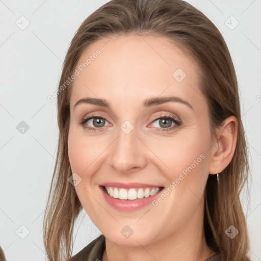 Joyful white young-adult female with long  brown hair and grey eyes