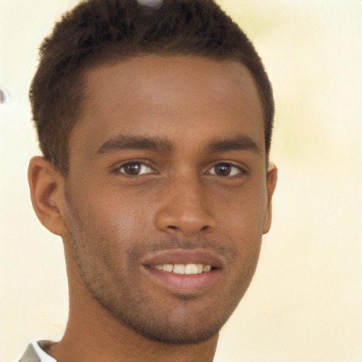 Joyful black young-adult male with short  brown hair and brown eyes