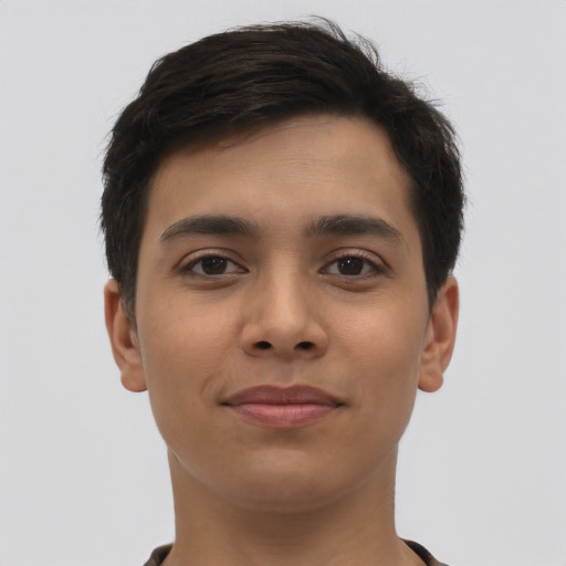 Joyful latino young-adult male with short  brown hair and brown eyes