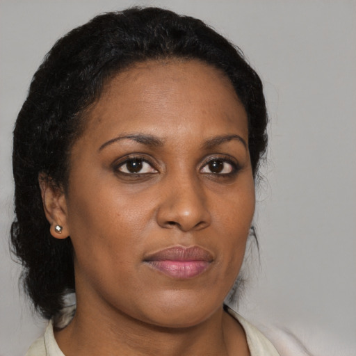 Joyful black young-adult female with medium  brown hair and brown eyes