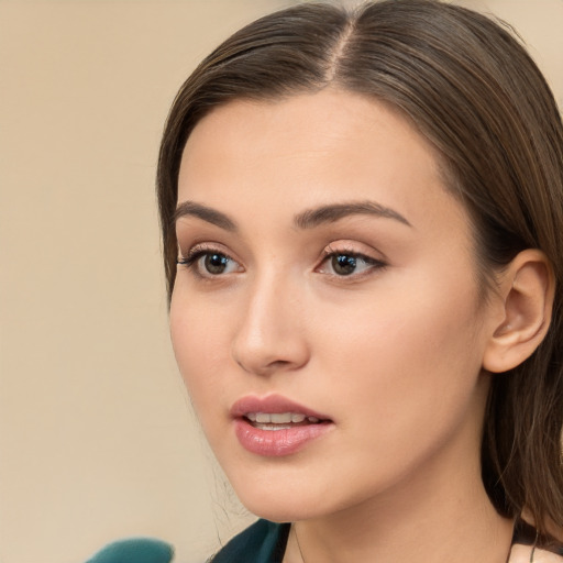 Neutral white young-adult female with long  brown hair and brown eyes