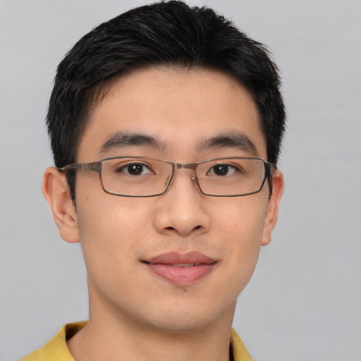 Joyful asian young-adult male with short  brown hair and brown eyes