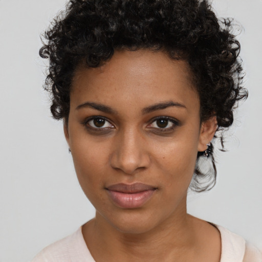 Joyful black young-adult female with short  brown hair and brown eyes