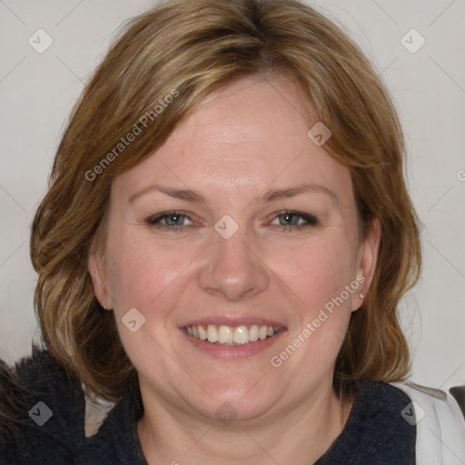 Joyful white adult female with medium  brown hair and blue eyes