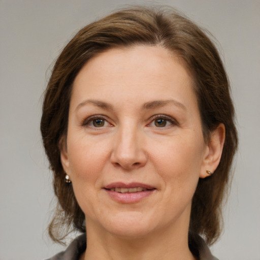 Joyful white adult female with medium  brown hair and brown eyes