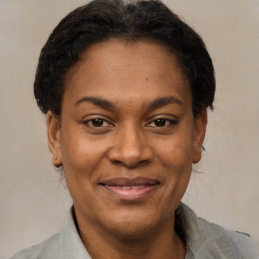 Joyful latino adult female with short  black hair and brown eyes