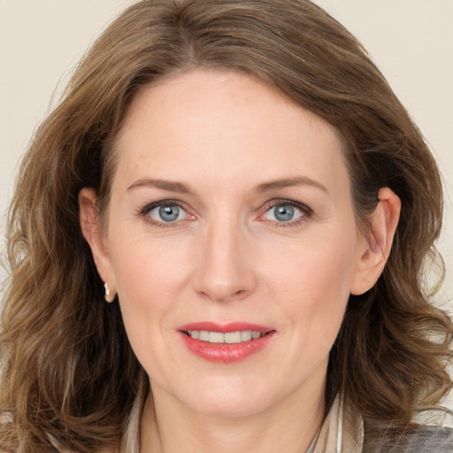 Joyful white adult female with long  brown hair and brown eyes