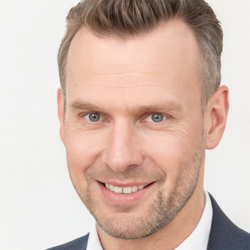 Joyful white adult male with short  brown hair and brown eyes