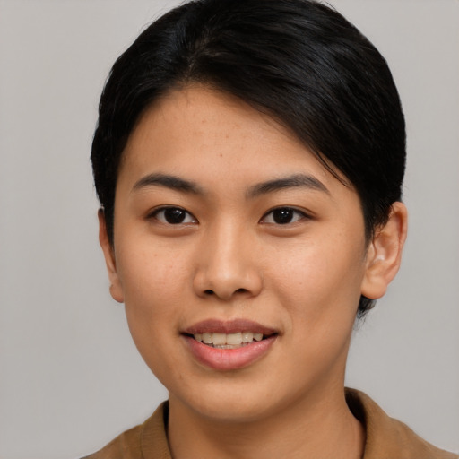 Joyful asian young-adult female with short  black hair and brown eyes