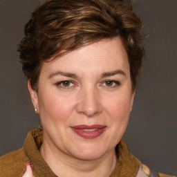 Joyful white adult female with medium  brown hair and blue eyes