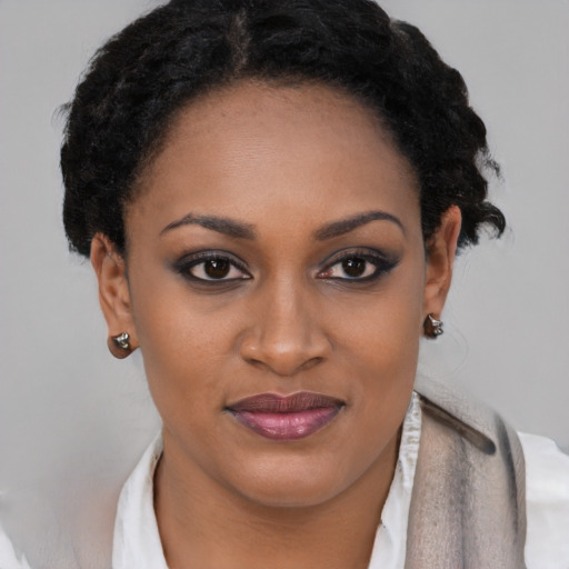 Joyful black young-adult female with short  brown hair and brown eyes