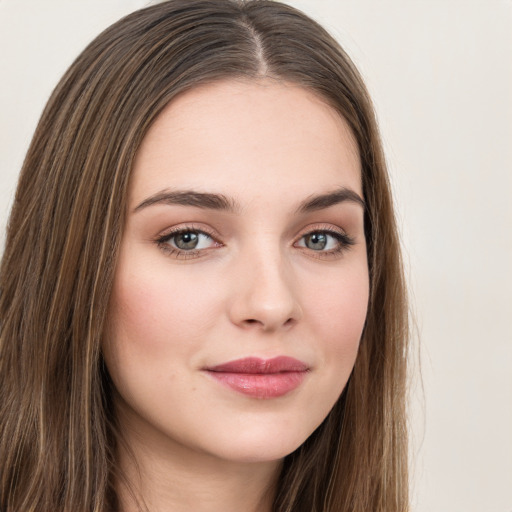 Joyful white young-adult female with long  brown hair and green eyes