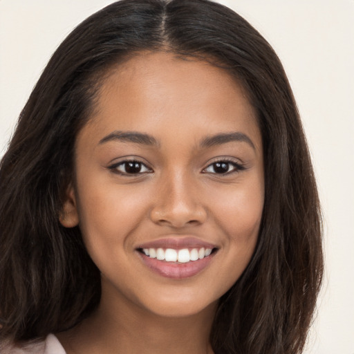 Joyful latino young-adult female with long  brown hair and brown eyes