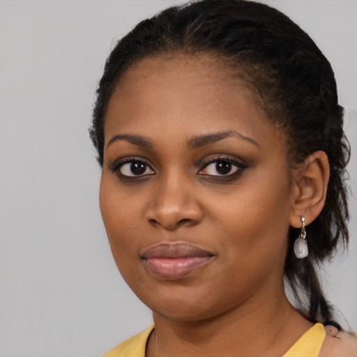 Joyful black young-adult female with medium  black hair and brown eyes