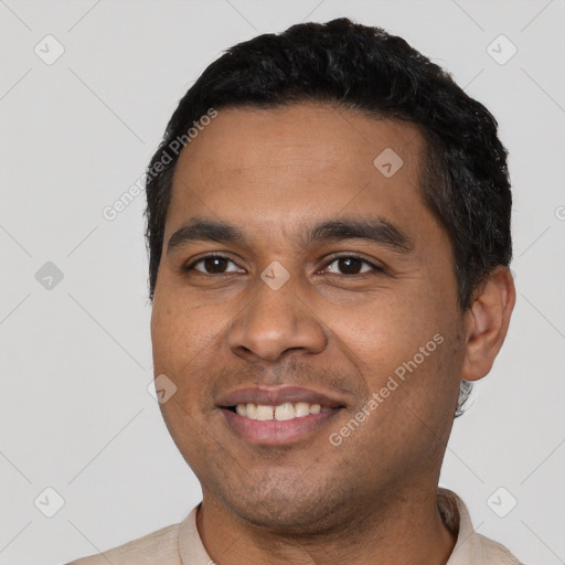 Joyful latino young-adult male with short  black hair and brown eyes