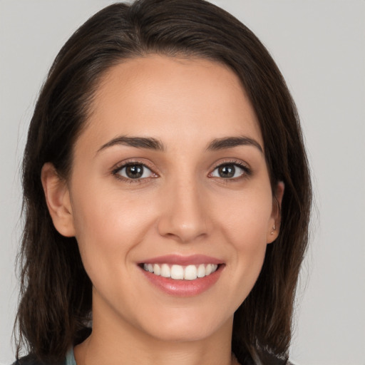 Joyful white young-adult female with medium  brown hair and brown eyes