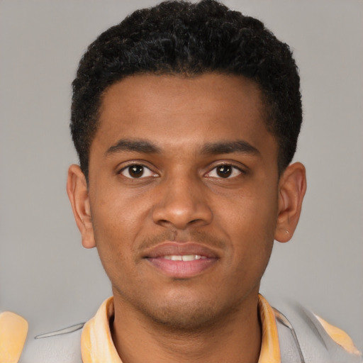 Joyful latino young-adult male with short  brown hair and brown eyes