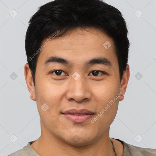 Joyful asian young-adult male with short  brown hair and brown eyes