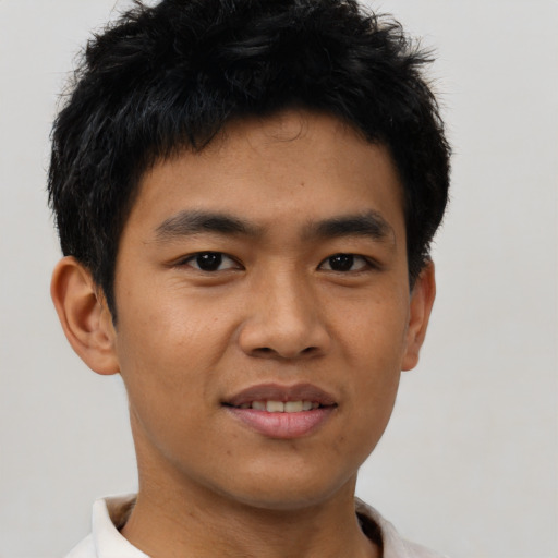 Joyful asian young-adult male with short  black hair and brown eyes