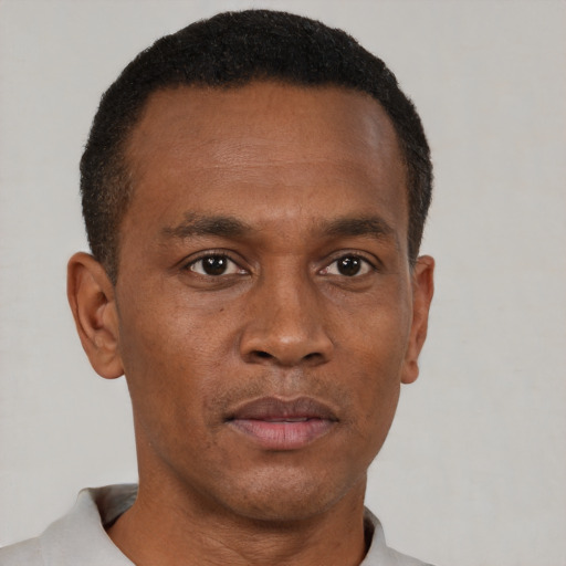 Neutral black adult male with short  black hair and brown eyes