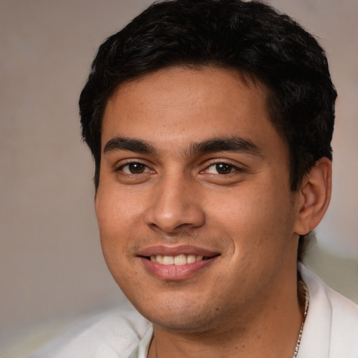 Joyful latino young-adult male with short  brown hair and brown eyes