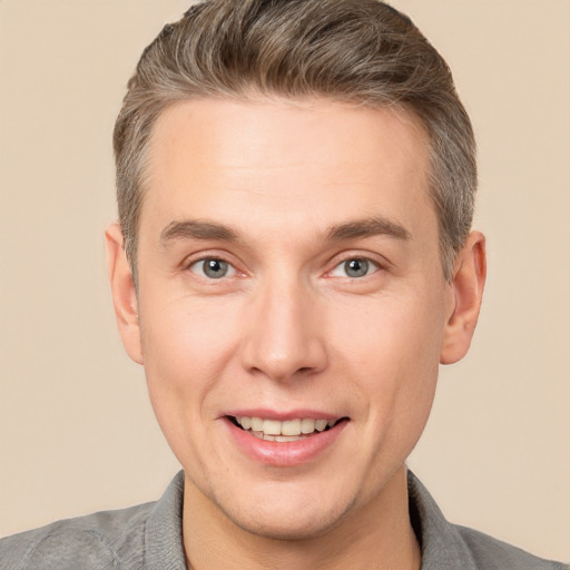 Joyful white adult male with short  brown hair and brown eyes