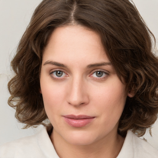 Joyful white young-adult female with medium  brown hair and green eyes