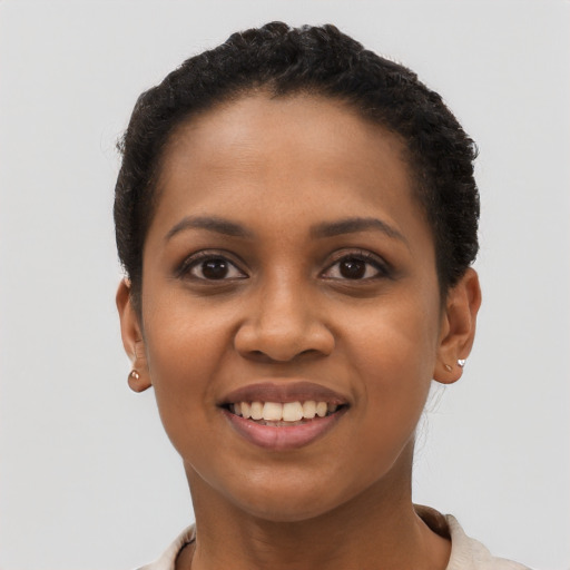 Joyful black young-adult female with short  brown hair and brown eyes