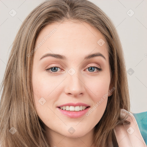 Joyful white young-adult female with long  brown hair and green eyes