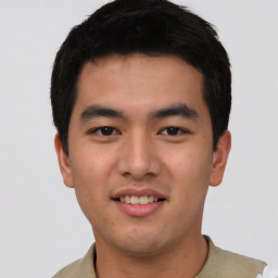 Joyful asian young-adult male with short  black hair and brown eyes