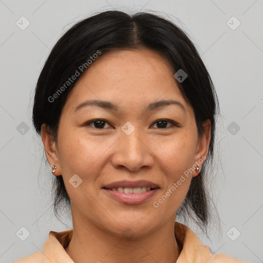 Joyful asian adult female with medium  brown hair and brown eyes