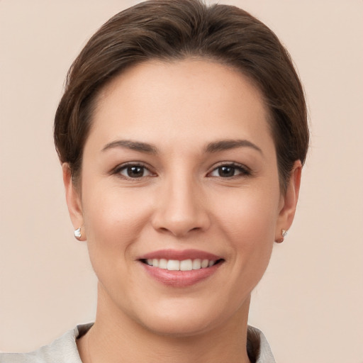 Joyful white young-adult female with short  brown hair and brown eyes