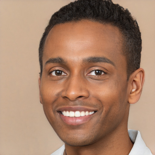 Joyful black young-adult male with short  brown hair and brown eyes