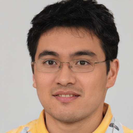 Joyful asian young-adult male with short  brown hair and brown eyes