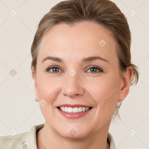 Joyful white young-adult female with medium  brown hair and grey eyes