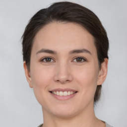 Joyful white young-adult female with medium  brown hair and brown eyes