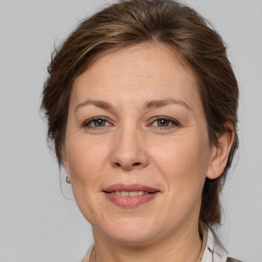 Joyful white adult female with medium  brown hair and brown eyes