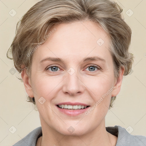 Joyful white adult female with medium  brown hair and grey eyes