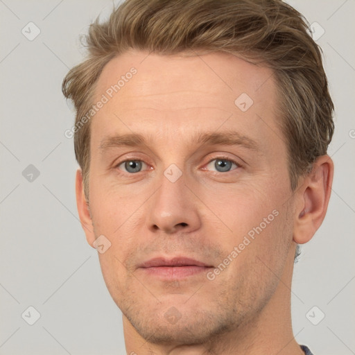 Joyful white adult male with short  brown hair and grey eyes