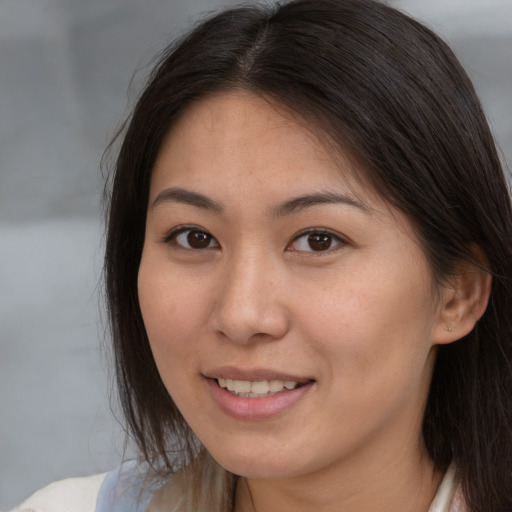 Joyful white young-adult female with medium  brown hair and brown eyes