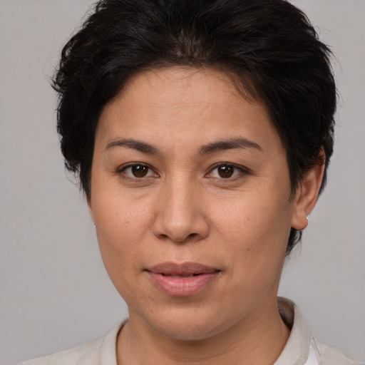 Joyful white adult female with short  brown hair and brown eyes
