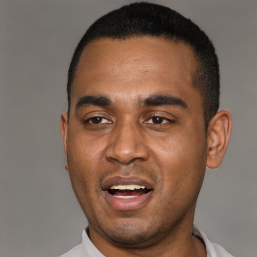Joyful black young-adult male with short  black hair and brown eyes