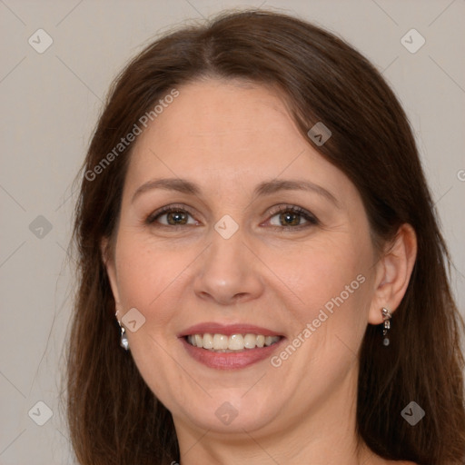 Joyful white adult female with long  brown hair and grey eyes