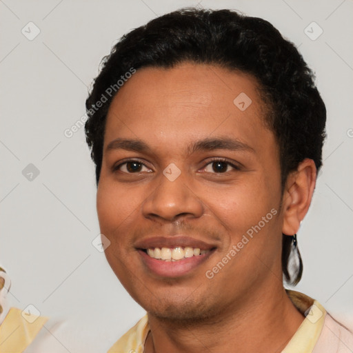 Joyful latino young-adult male with short  black hair and brown eyes