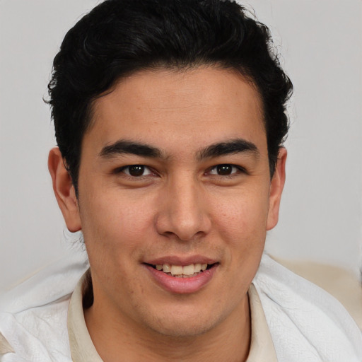 Joyful latino young-adult male with short  brown hair and brown eyes