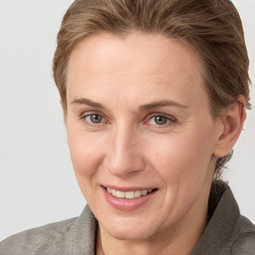 Joyful white adult female with short  brown hair and grey eyes