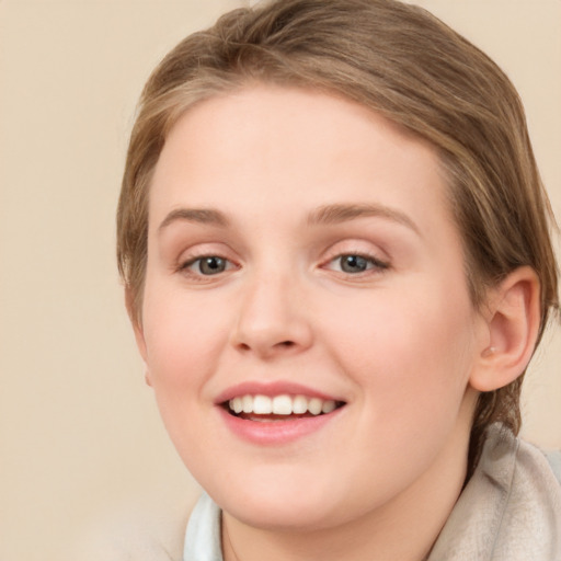 Joyful white young-adult female with medium  brown hair and grey eyes